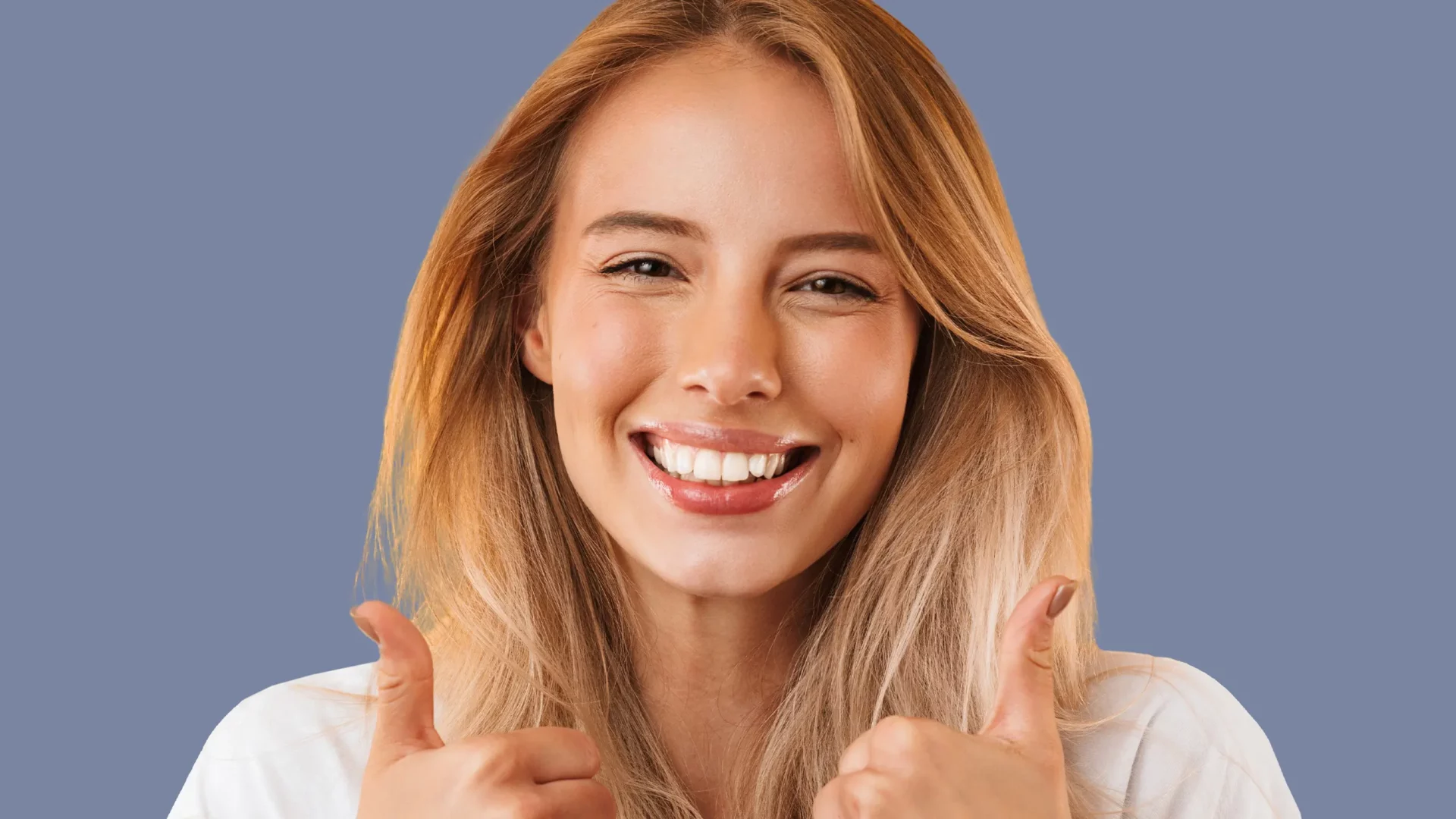 Lächelnde Patientin zeigt mit beiden Daumen hoch